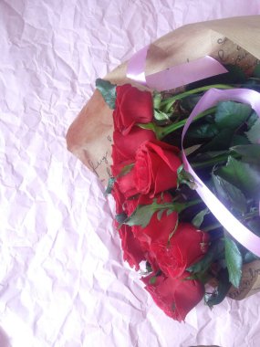 layout greeting card. beautiful bouquet of red roses and space for text.