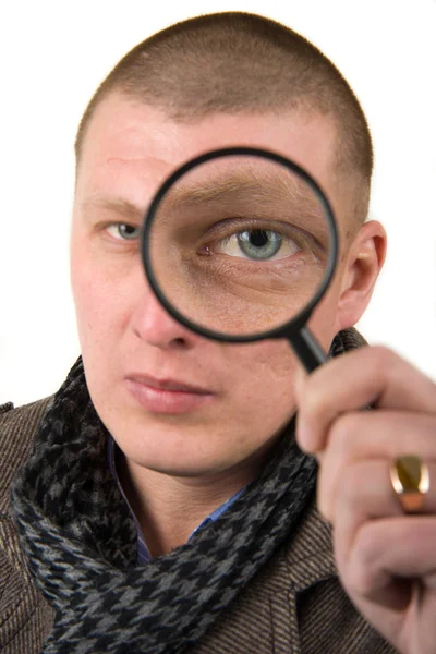 Young man with magnifying glass — Stock Photo, Image
