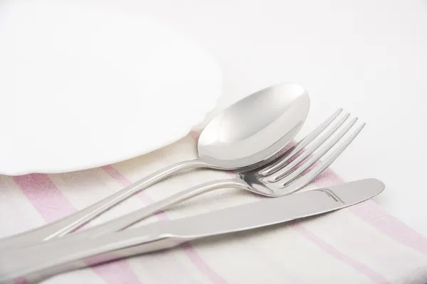 Knife, fork and spoon with napkin — Stock Photo, Image