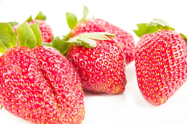 Strawberries over white background, selective focus — Stock Photo, Image