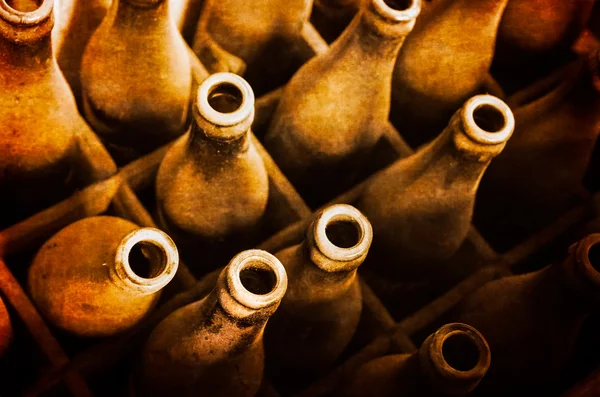 Old dusty beer bottles in wooden case — Stock Photo, Image