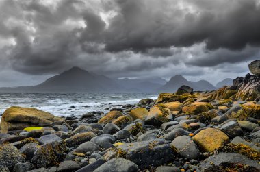 Landscape coastline view of rocks and Cullin hills, Scotland clipart