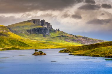 Landscape view of Old Man of Storr rock formation and lake, Scot clipart
