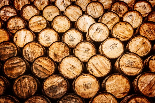 Detail view of stacked whisky and wine wooden barrels — Stock Photo, Image