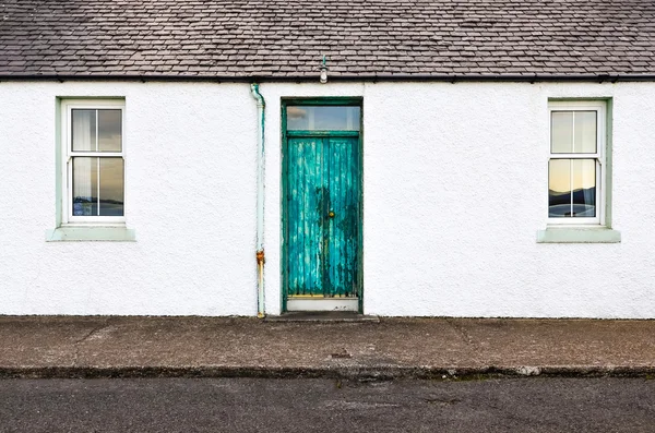 Green door and two windows on white wall house — Stock Photo, Image