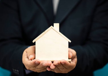 Ahşap ev ellerde. Tutmak, bakmak ve en iyi şeyi başkalarına vermek anlamına gelir.