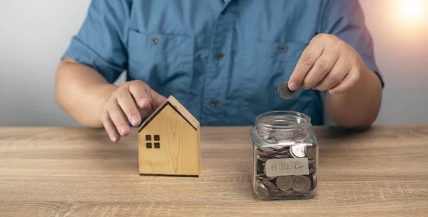 Man Putting Money Jar Bank Future Home Purchases Money Saving — Stockfoto