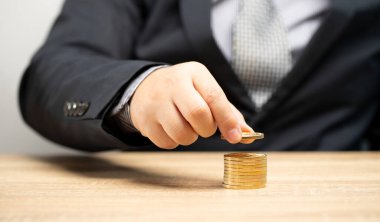 İşadamı, gelecekteki finansal yatırım para planlama teorisine altın para yatırıyor.