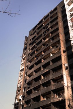 A destroyed high-rise building with people in Kharkov after the shelling of Russian troops. War of Russia against Ukraine. Copyspace.