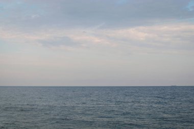 Calm sea with a ship sailing in the distance. Copyspase.