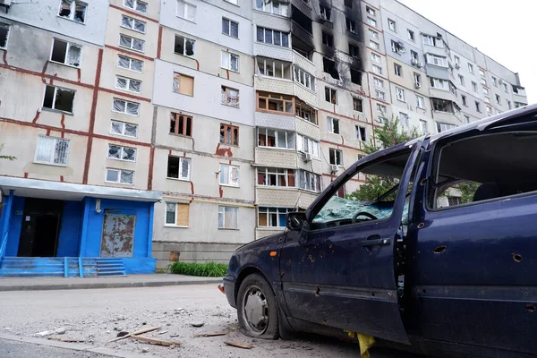 Consequences of the war in Ukraine, destroyed houses and burned cars. Shot, burned cars of civilians. War of Russia against Ukraine. Cars damaged after shelling. Kharkov, Ukraine. War crimes.