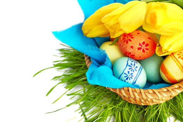 Easter eggs in basket with tulips — Stock Photo, Image