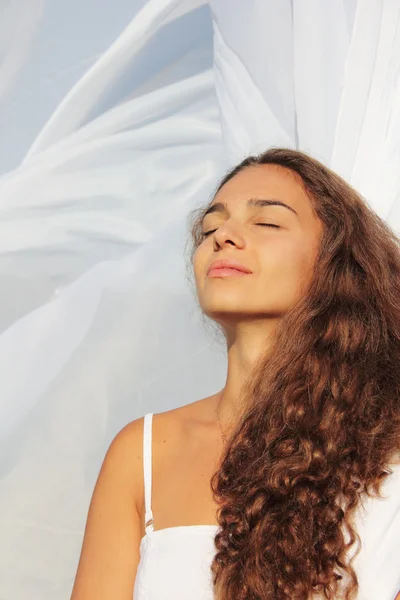 Young woman in fabric background — Stock Photo, Image