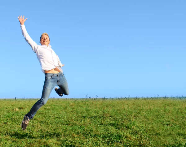 Man jumping on summer field — Stock Photo, Image