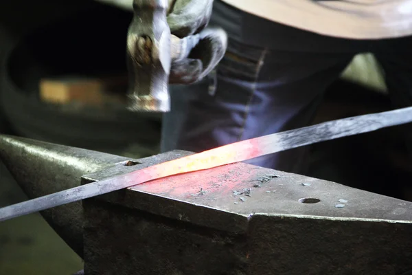 Blacksmith in a forge — Stock Photo, Image