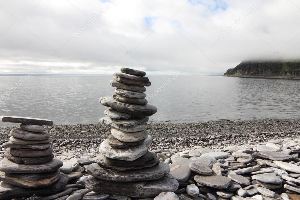 Stack of stones on fjord background