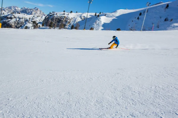 Sciatore Maschile Abiti Blu Gialli Pista Con Montagne Sullo Sfondo — Foto Stock