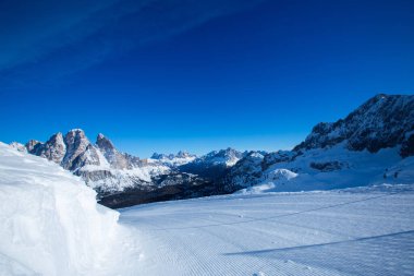 Dolomities Dolomiti Italy in wintertime beautiful alps winter mountains and ski slope Cortina d'Ampezzo Faloria skiing resort area clipart
