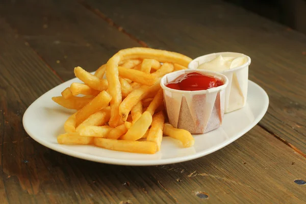 French fries with condiment — Stock Photo, Image
