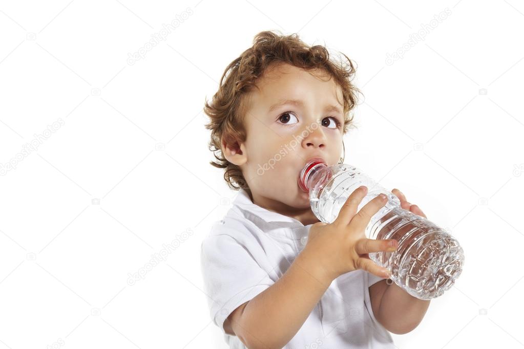 Portrait of the boy drinking water from a bottle.