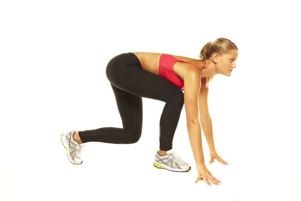 Athletic woman on track starting to run — Stock Photo, Image