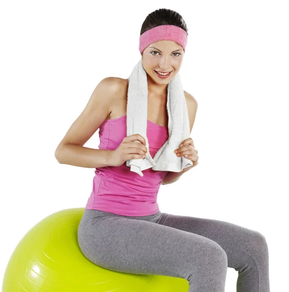 Fitness young woman with towel around her neck smiling — Stock Photo, Image