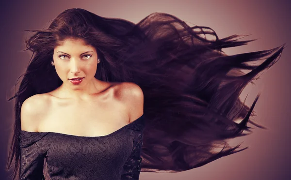 Young brunette woman with long flying hair - retro style — Stock Photo, Image