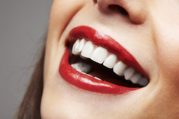 Smiling woman mouth with great teeth. Over white background