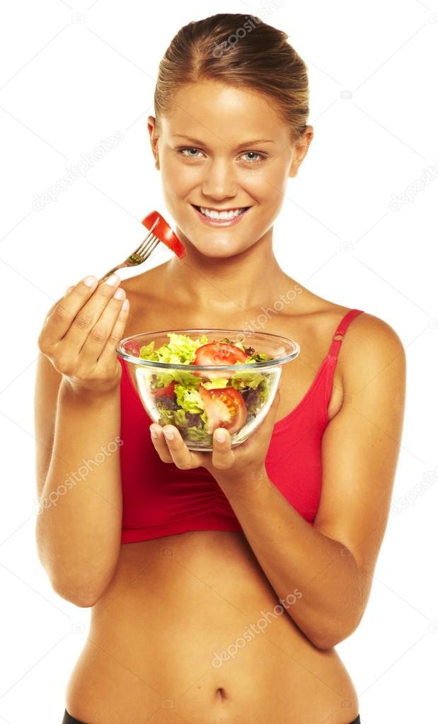 Beautiful sport woman eating salad