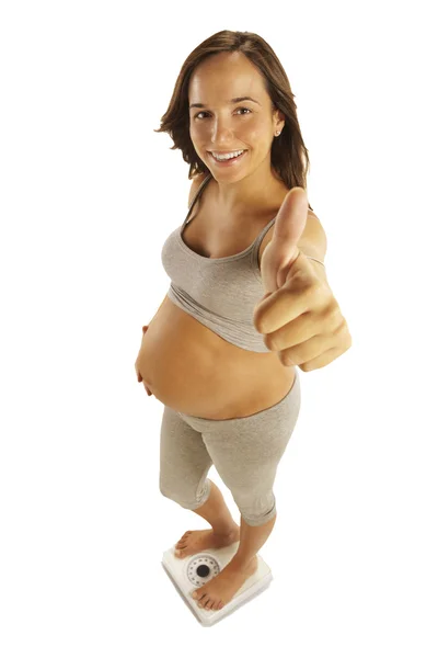 Beautiful pregnant woman showing the sign OK — Stock Photo, Image