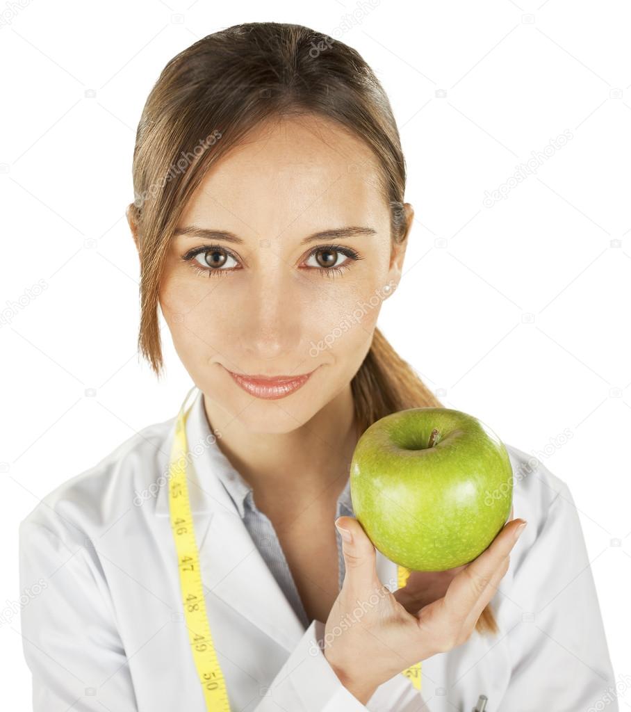 Woman doctor with a green apple. Nutritionist