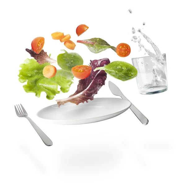 Light salad with floating vegetables — Stock Photo, Image