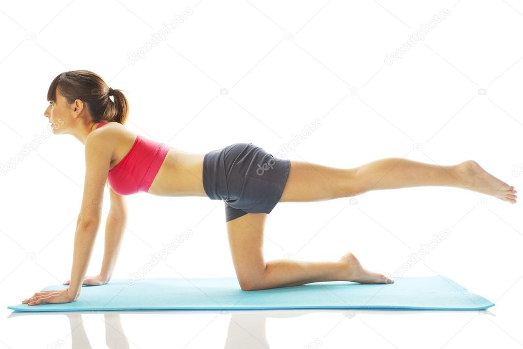 Young fitness woman doing pilates exercise