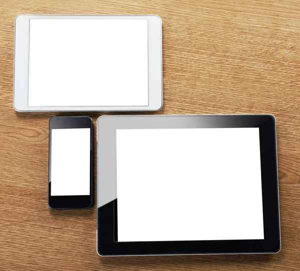 Different types of digital tablet and smart phone on a desktop — Stock Photo, Image