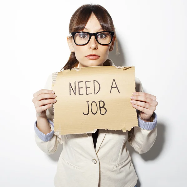 Young business woman holding a poster that says need a job — Stock Photo, Image