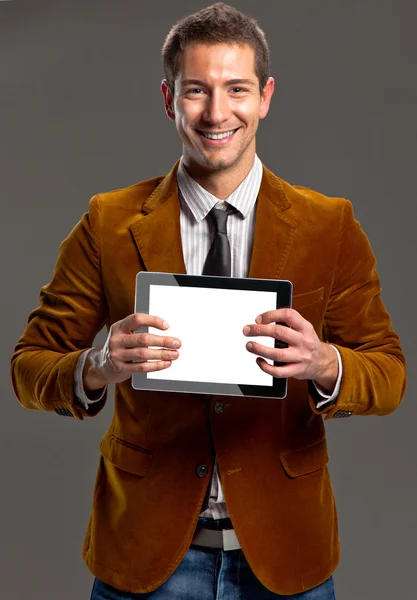 Young businessman showing a tablet screen. — Stock Photo, Image