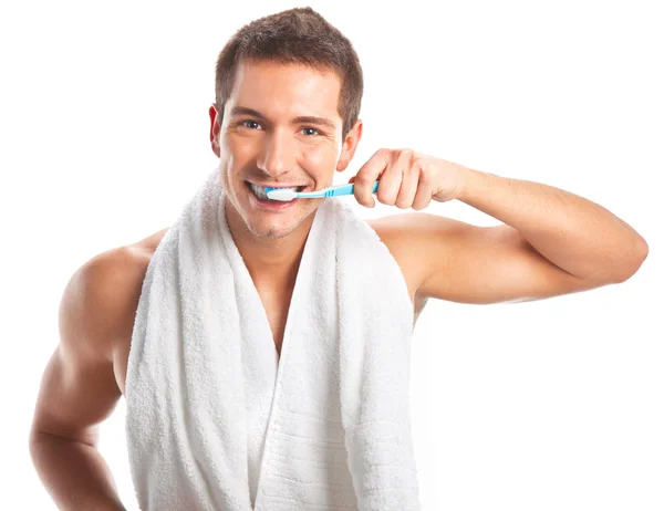 Young man brushing his teeth — Stock Photo, Image