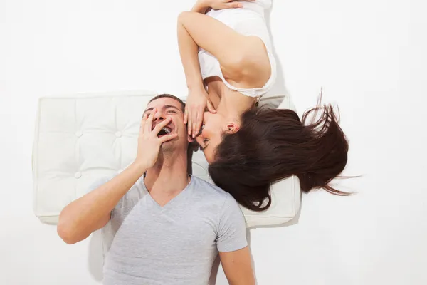 Young couple lying. She whispers and he laughs — Stock Photo, Image