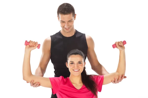 Mujer con su entrenador personal de fitness haciendo ejercicio con pesas —  Fotos de Stock