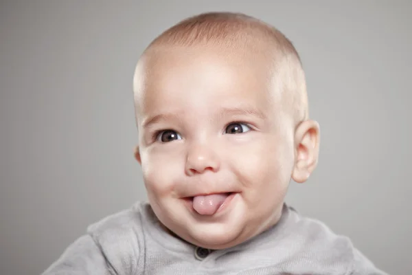 Retrato de un bebé pegando su lengua — Foto de Stock