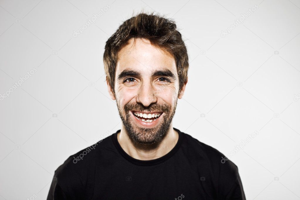 Portrait of a normal boy laughing isolated on white