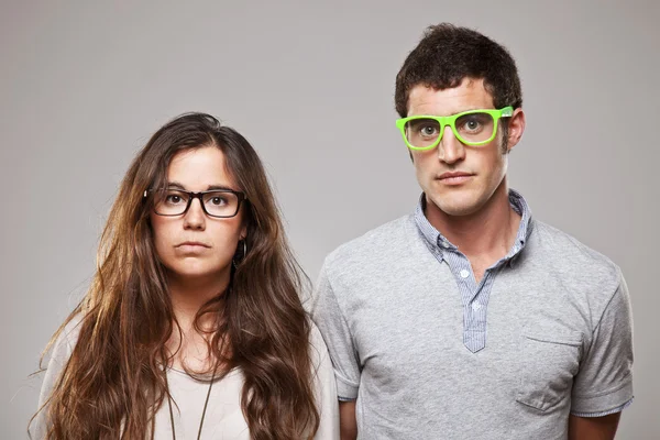 Portrait of a beautiful young happy smiling couple with glasses — Stock Photo, Image