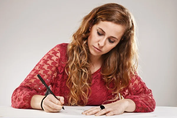 Kvinnlig student skriver på anteckningsboken — Stockfoto