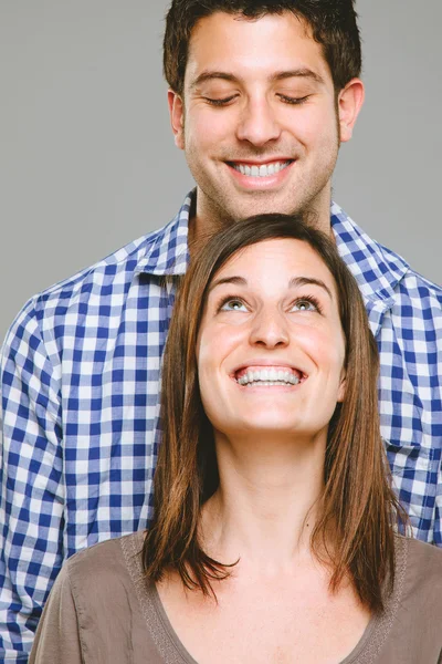 Portrait of a beautiful young couple looking in — Stock Photo, Image