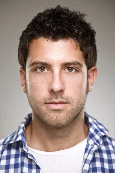 Portrait of a normal young man on a grey background — Stock Photo, Image