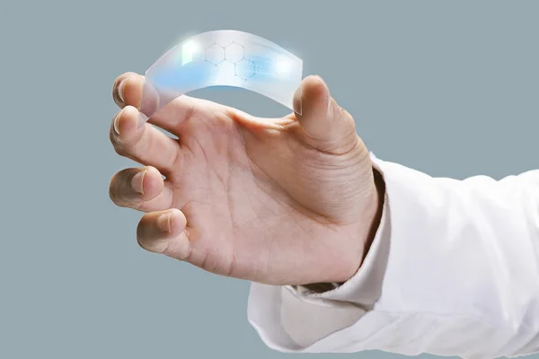 Close up of a scientific holding one piece transparent of graphene application. — Stock Photo, Image