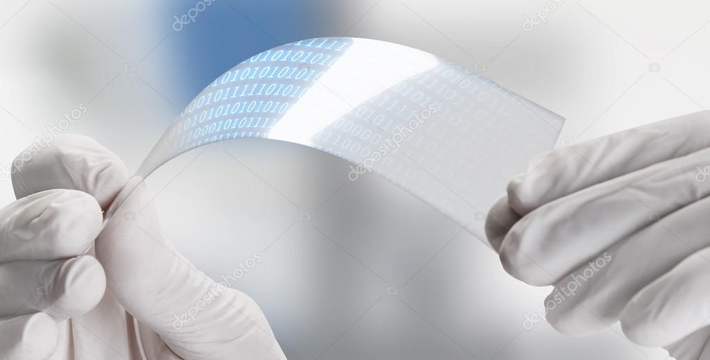 Close up of a scientific holding one piece transparent of graphene application with binary numbers.