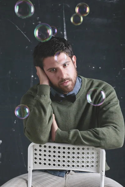 Stressed teacher man wearing stylish clothes in front a blackboard. — Stock Photo, Image