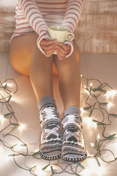 Woman with cozy socks on Christmas time. — Stock Photo, Image
