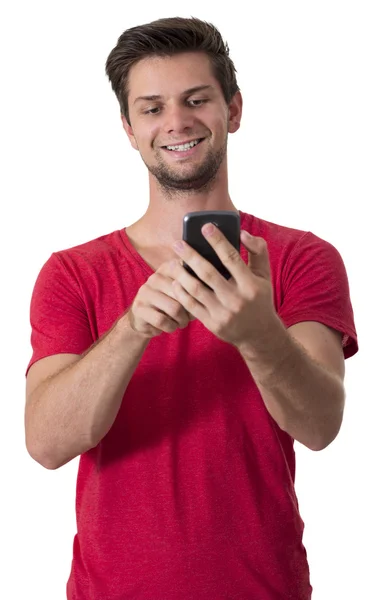 Молодой человек работает над своим смартфоном Лицензионные Стоковые Фото